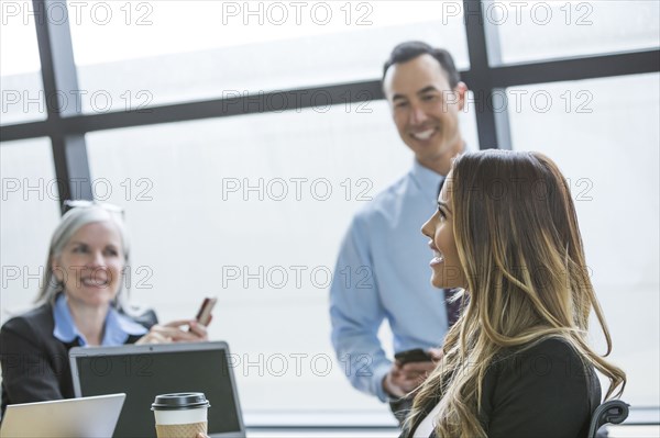 Business people smiling in meeting