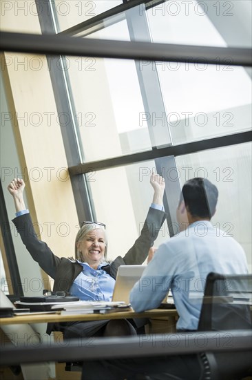 Business people celebrating in meeting