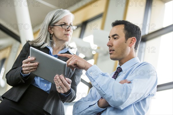 Serious business people using digital tablet