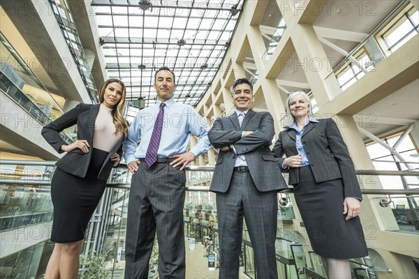 Portrait of smiling business people in lobby