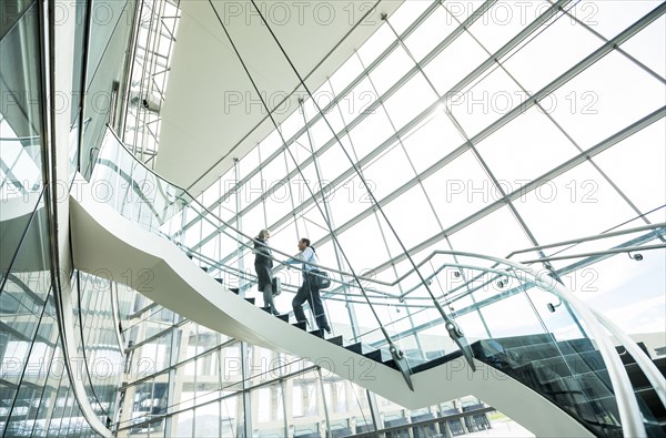 Business people standing on staircase and talking