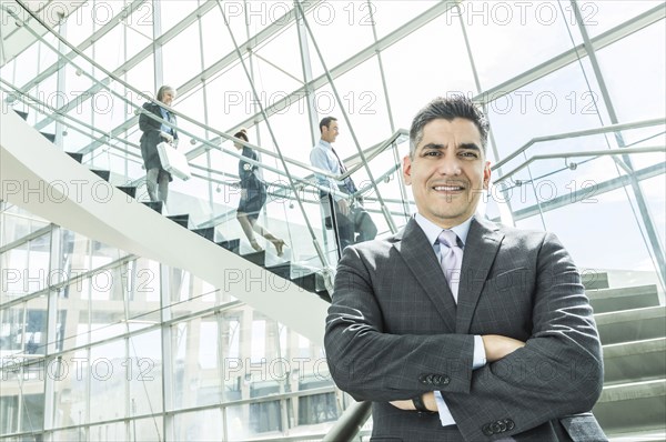 Portrait of businessman standing near staircase