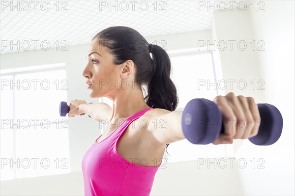 Caucasian woman lifting weights