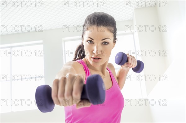 Caucasian woman lifting weights