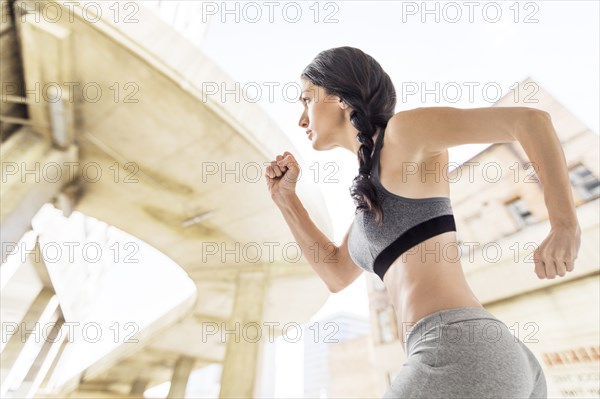 Caucasian woman running in city