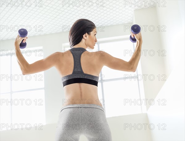 Caucasian woman lifting weights