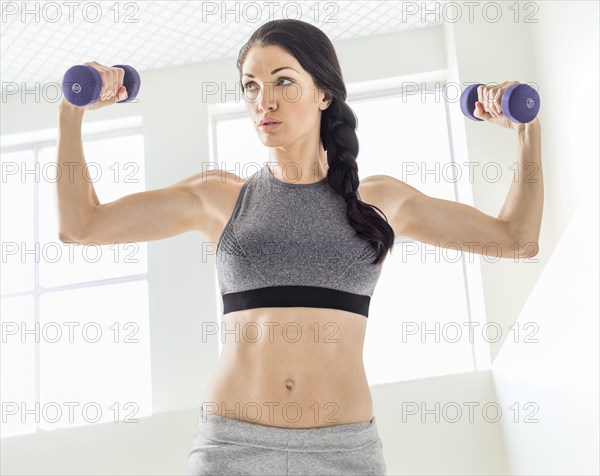 Caucasian woman lifting weights