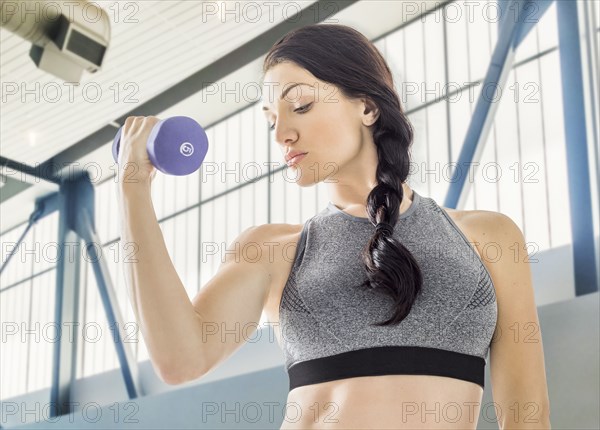 Caucasian woman lifting weights