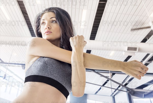 Caucasian woman stretching arm