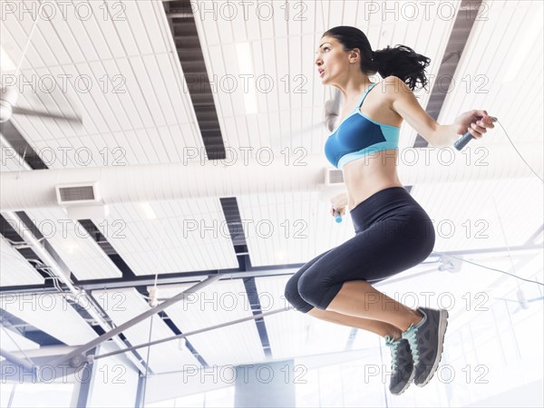 Caucasian woman jumping rope