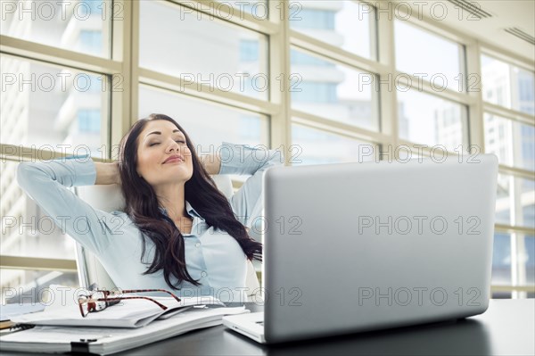 Caucasian businesswoman unwinding in office