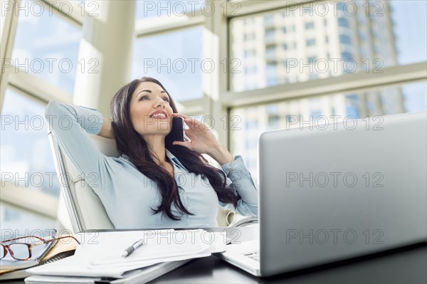 Caucasian businesswoman talking on cell phone