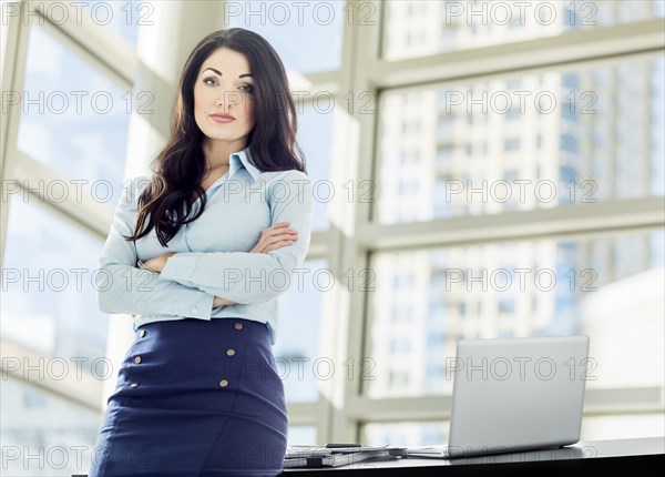 Caucasian businesswoman posing in office