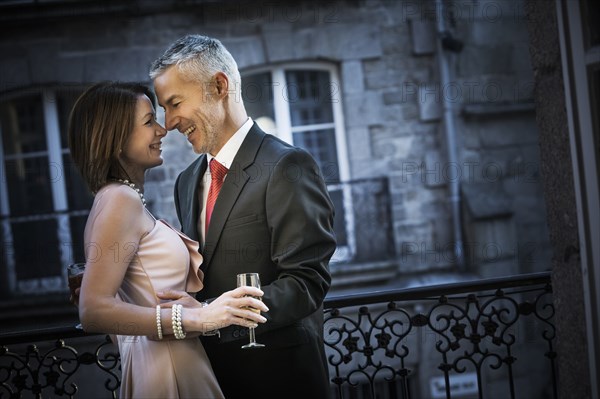 Well-dressed Caucasian couple rubbing noses