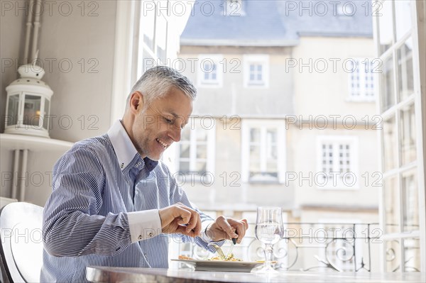 Caucasian man eating meal