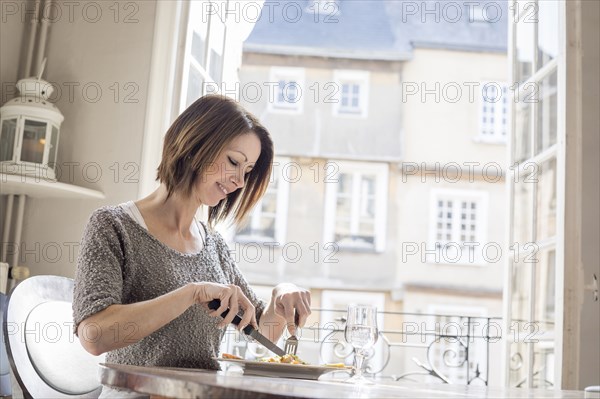 Caucasian woman eating a meal