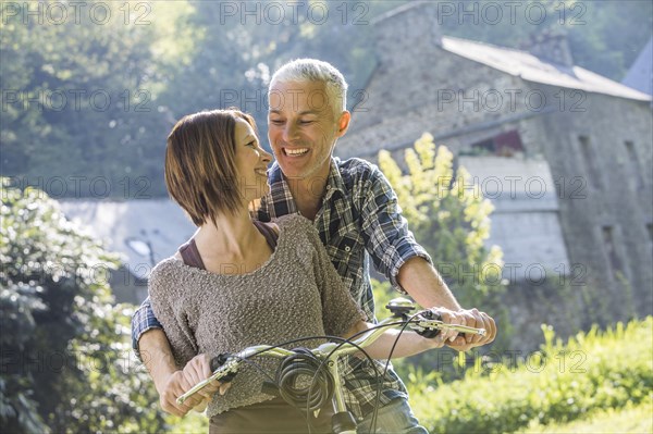 Caucasian couple riding bicycle