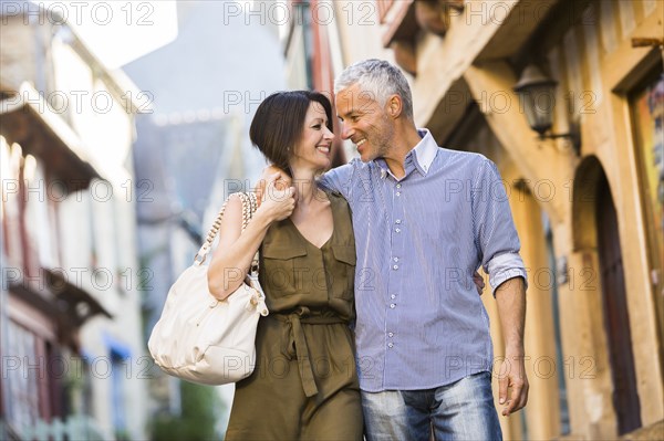 Caucasian couple hugging in the city