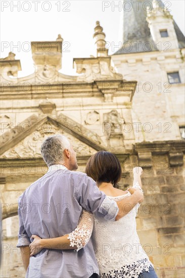 Caucasian couple admiring building