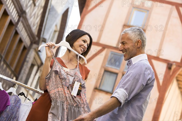 Caucasian woman asking man for advice about dress
