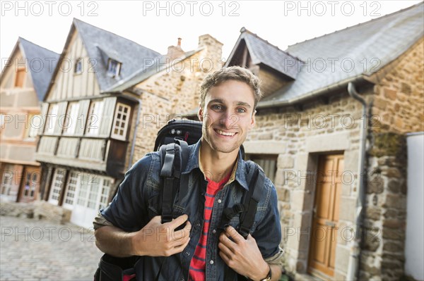 Caucasian man backpacking in city