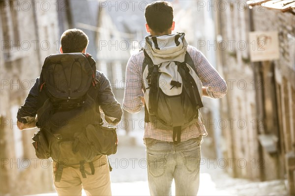 Men backpacking in city