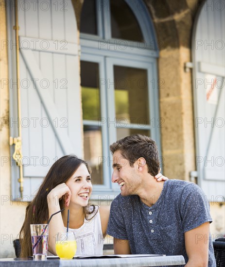 Caucasian couple hugging at restaurant