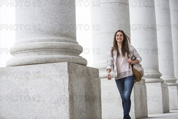 Caucasian woman carrying backpack at school