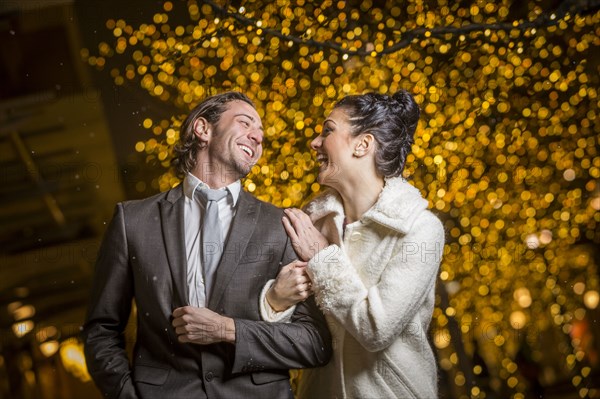 Caucasian couple laughing outdoors