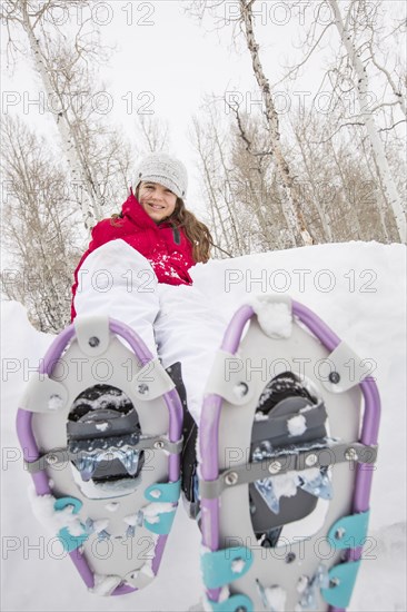 Portrait of smiling Caucasian girl wearing snowshoes