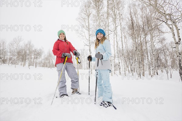 Portrait of Caucasian mother and daughter snowshoeing