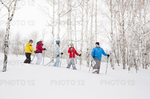 Caucasian family snowshoeing