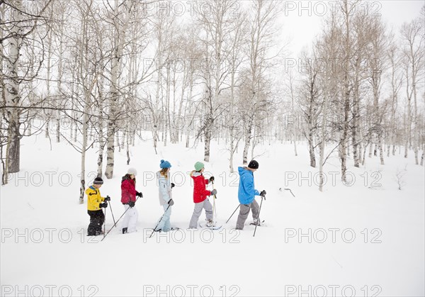 Caucasian family snowshoeing