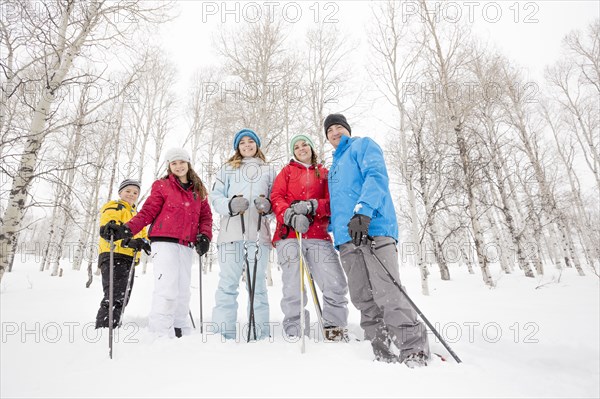 Portrait of smiling Caucasian family snowshoeing