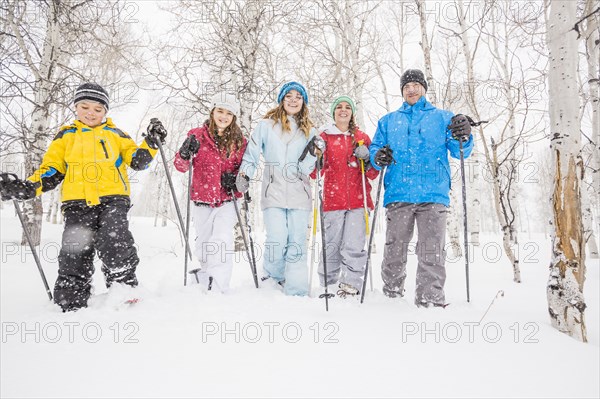 Portrait of smiling Caucasian family snowshoeing