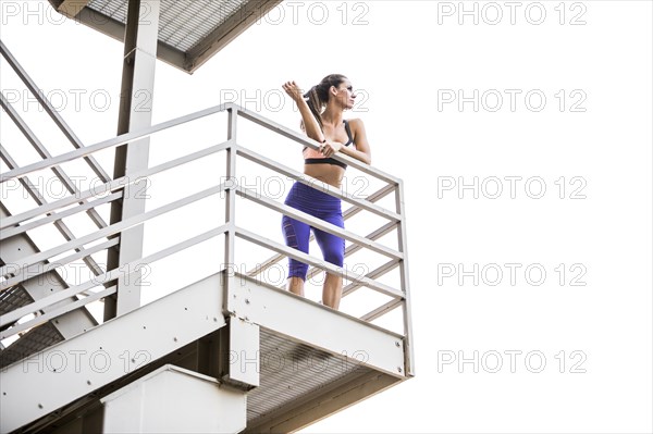 Caucasian woman leaning on urban staircase