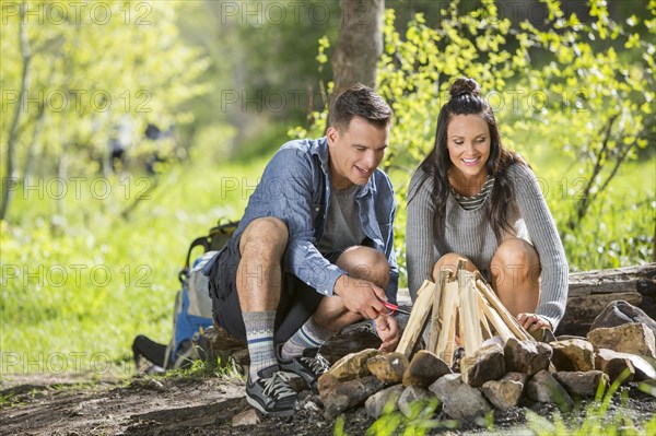 Couple building campfire in the woods