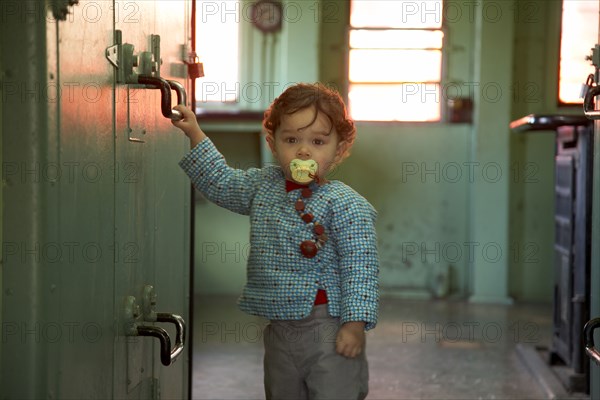 Mixed race boy standing in kitchen