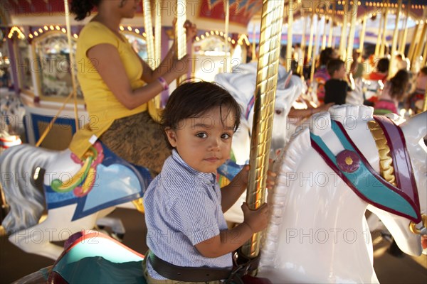 Mother and son on merry-go-round