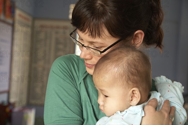 Mother hugging baby