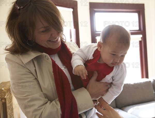 Mother holding baby girl