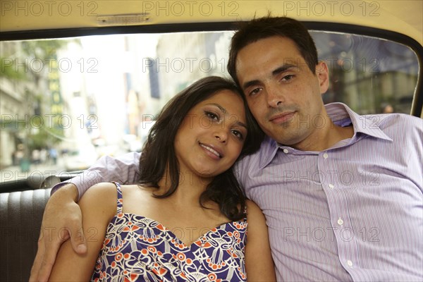 Couple hugging in back of taxi