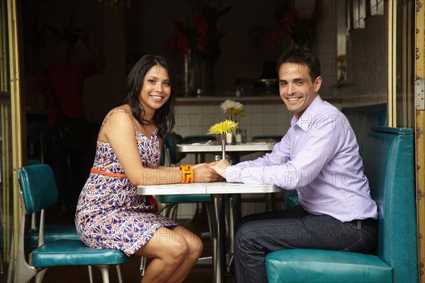 Couple holding hands in restaurant