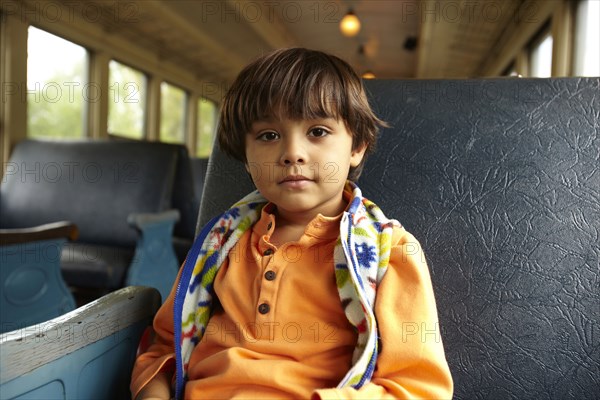 Mixed race boy riding on train