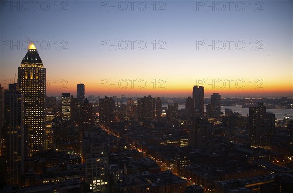 Sunset and illuminated cityscape