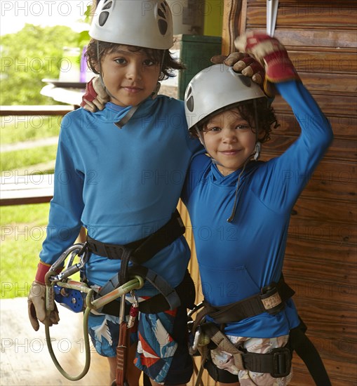 Mixed race boys preparing to zip line