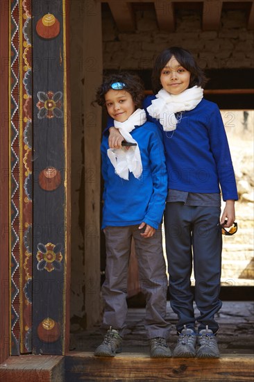 Mixed Race brothers hugging in doorway