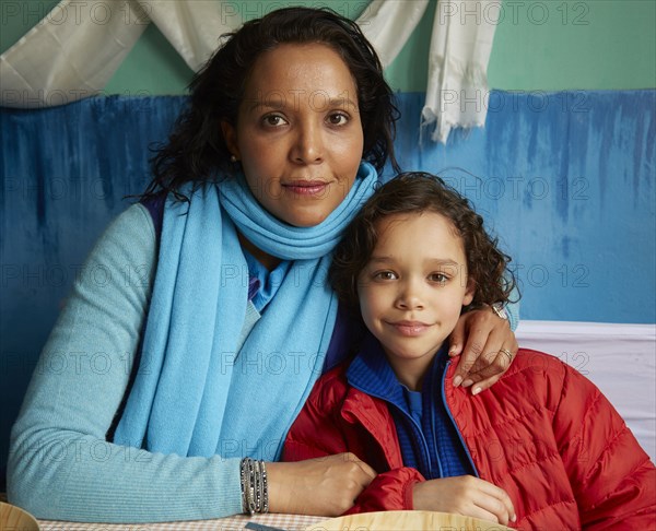 Mixed Race mother hugging son