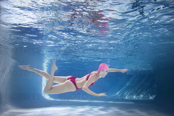 Caucasian woman in bikini swimming underwater