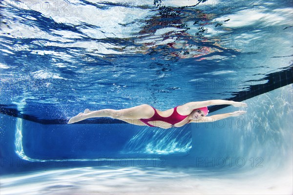 Caucasian woman swimming underwater